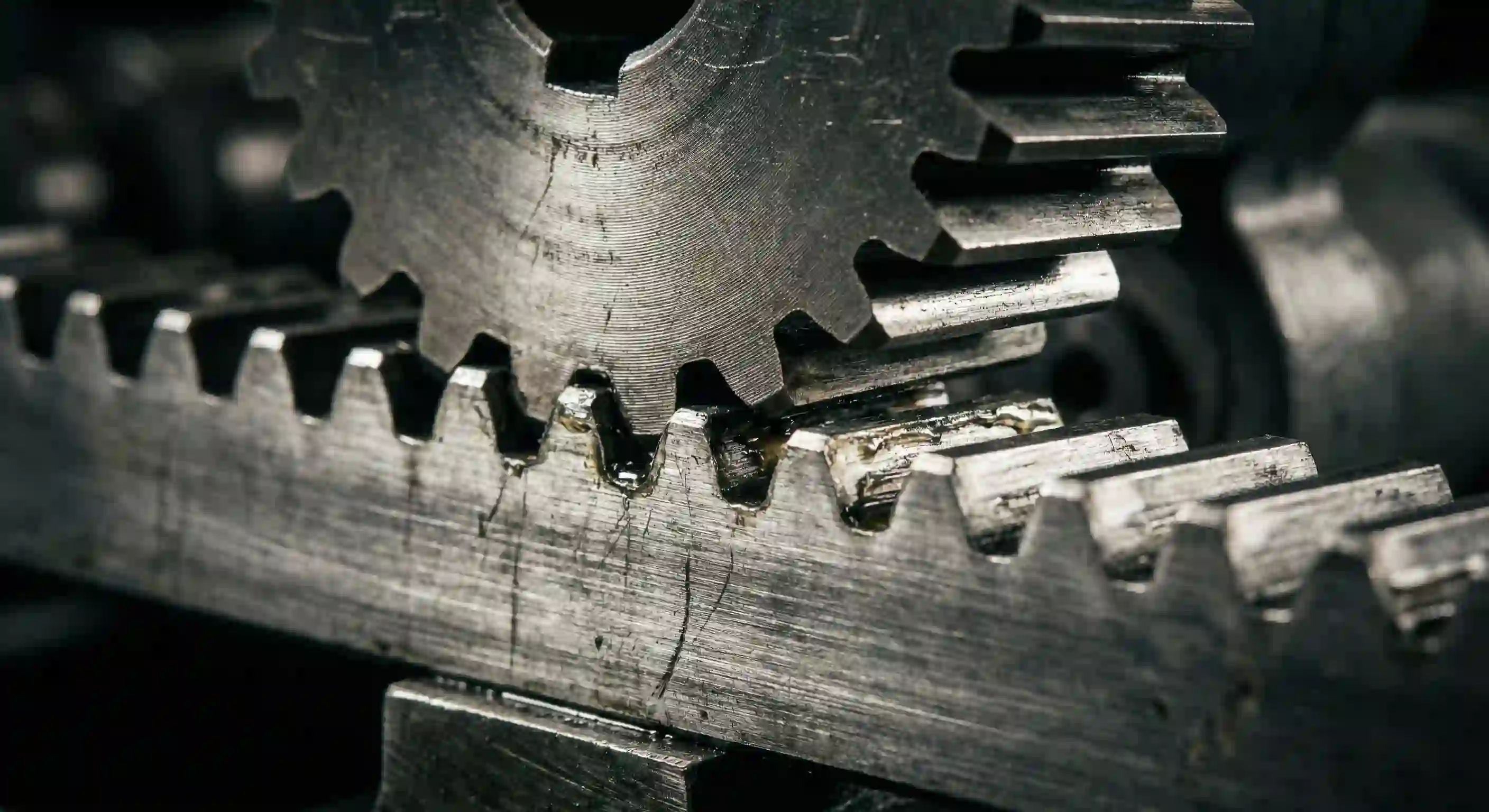 Steel gear rack meshing with motor cog, showing precision and detail.