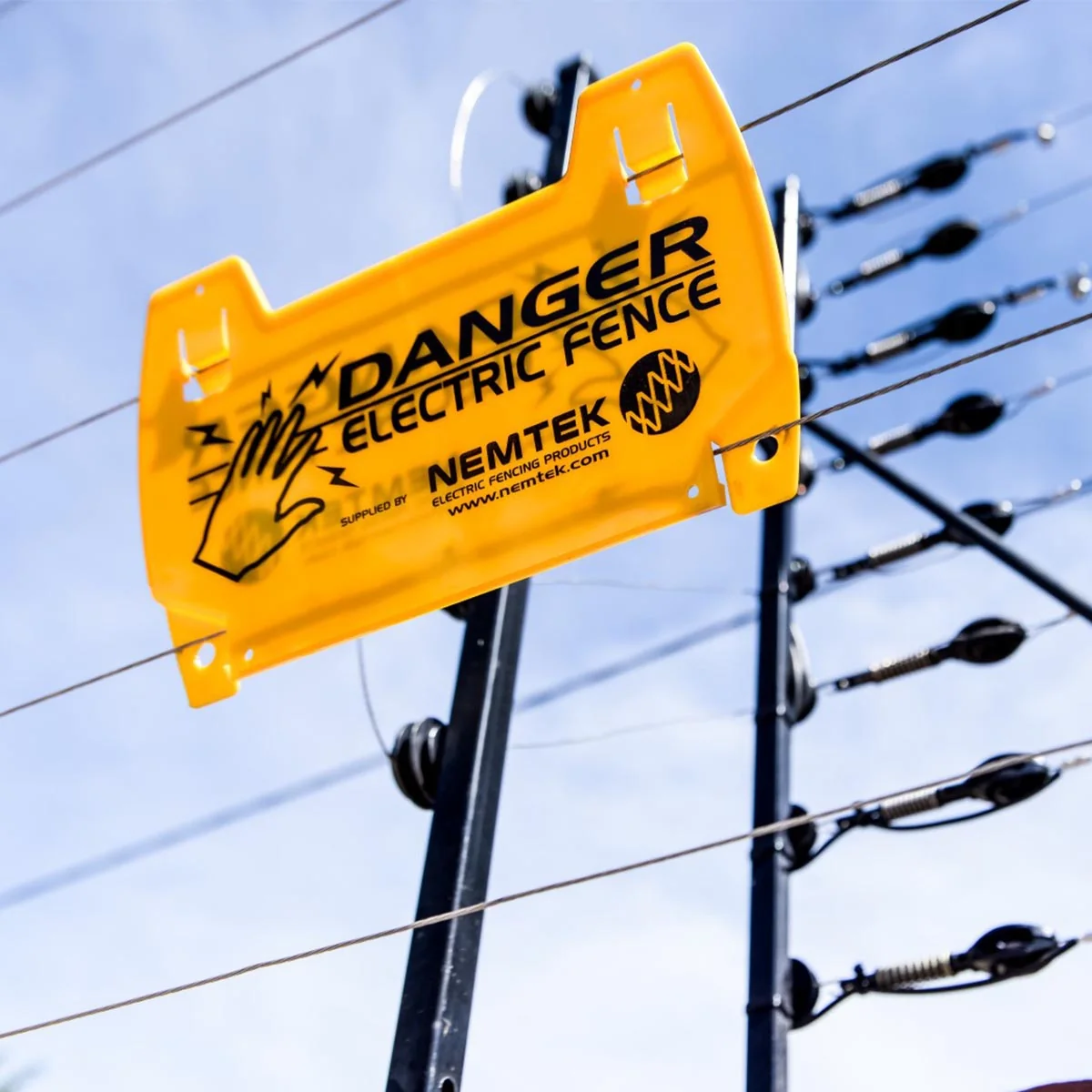 Nemtek energizer installed beside a wall-top electric fence in Pakistan